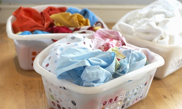Clean washing in three plastic laundry baskets