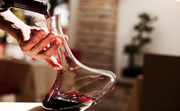 Waiter pouring the wine in a glass