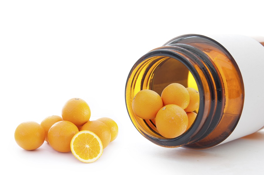 Miniature oranges inside a vitamin pill container