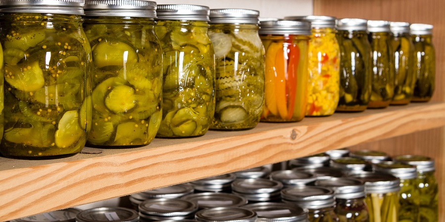 M1582P Jars of home canned fruits and vegetables on wooden shelves