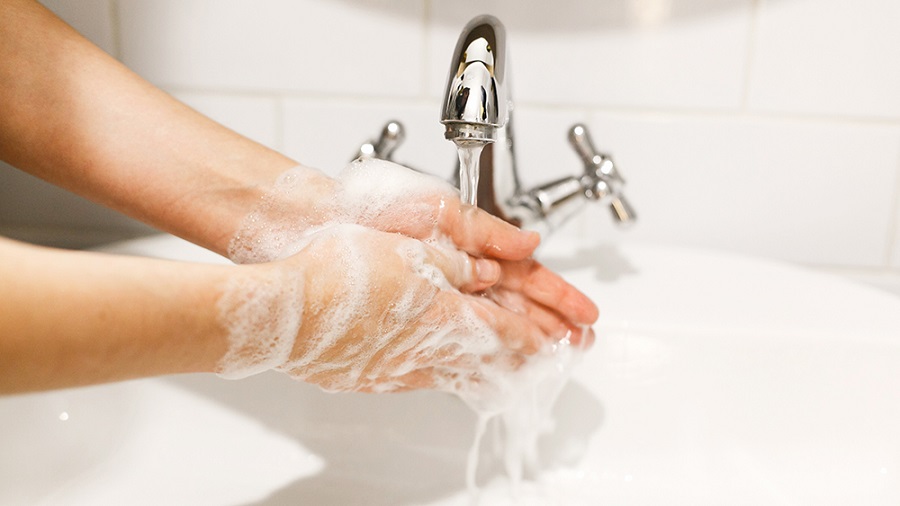 Washing hands. Hands washing with proper technique and antibacterial soap on background of flowing water in bathroom. Rubbing fingers. Prevent coronavirus epidemic. Prevention of flu disease.; Shutterstock ID 1671102841; Notes: RR digital