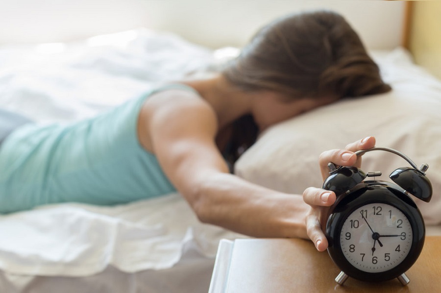 Wake up of a girl stopping alarm clock