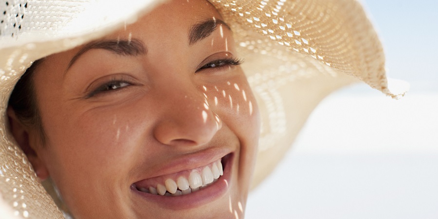 Close up of woman wearing sun hat
