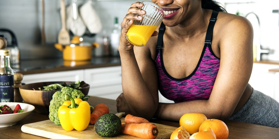 Black woman is drinking orange juice
